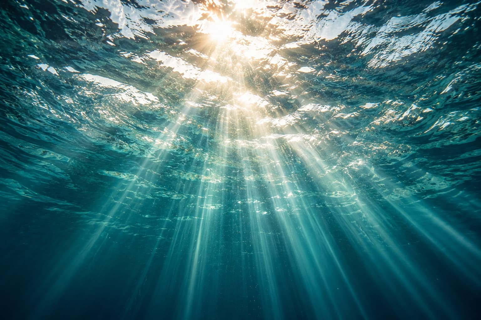 Sun rays beneath the blue water surface