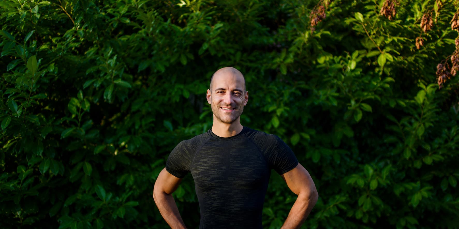 Portrait of Philip in front of green plants